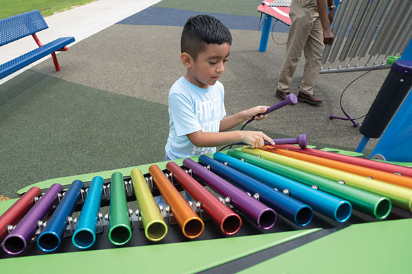 Child playing with Xylophone on playground